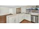 Bright kitchen featuring white cabinets, stainless steel appliances, and modern fixtures at 4743 W Laurel Ln, Glendale, AZ 85304