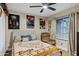 Comfortable bedroom featuring a ceiling fan, cozy bedding, and a relaxing armchair at 4918 W Butler Dr, Chandler, AZ 85226