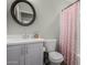Bathroom featuring white vanity, round mirror, and a polka dot shower curtain at 5016 N 68Th Dr, Glendale, AZ 85303