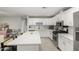 Bright modern kitchen with white cabinets, stainless steel appliances, and a large island at 5016 N 68Th Dr, Glendale, AZ 85303