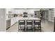 Modern kitchen with white cabinets, stainless steel appliances, and a spacious center island with seating at 5016 N 68Th Dr, Glendale, AZ 85303