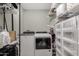 Organized laundry room with a Whirlpool washer and dryer set and ample shelving for storage solutions at 5016 N 68Th Dr, Glendale, AZ 85303