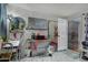A multi-use room boasts a mounted TV, dining set, and door to backyard, providing flexible living at 5016 N 68Th Dr, Glendale, AZ 85303
