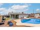 A beautiful inground pool with concrete patio, adjacent covered patio, and tidy landscaping at 5016 N 68Th Dr, Glendale, AZ 85303