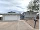 Charming home featuring a spacious driveway and a manicured front yard at 5133 W Hearn Rd, Glendale, AZ 85306