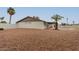 Spacious backyard with a pool, patio, rock landscaping and block fence at 5561 W Greenbriar Dr, Glendale, AZ 85308