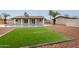 Spacious backyard features a pool, artificial turf, and a custom BBQ area perfect for entertaining at 5561 W Greenbriar Dr, Glendale, AZ 85308