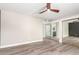 Bedroom with wood-style tile floors, mirrored closet doors, and an en-suite bathroom at 5561 W Greenbriar Dr, Glendale, AZ 85308
