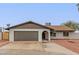 Charming single-story home with a well-maintained yard, an attached two-car garage and neutral color palette at 5561 W Greenbriar Dr, Glendale, AZ 85308