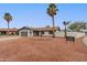 Charming single-story home with low-maintenance landscaping, a mature palm tree, and an attached two-car garage at 5561 W Greenbriar Dr, Glendale, AZ 85308