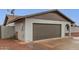 Spacious two-car garage with a neutral color palette and low-maintenance landscaping for easy upkeep at 5561 W Greenbriar Dr, Glendale, AZ 85308