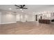 Open floor plan to a modern kitchen featuring a breakfast bar, and wood-style tile flooring at 5561 W Greenbriar Dr, Glendale, AZ 85308
