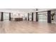 Expansive living room flows into the modern kitchen, creating an inviting space for entertaining and everyday living at 5561 W Greenbriar Dr, Glendale, AZ 85308