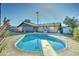 Backyard view featuring an in-ground pool with diving board, lawn and covered patio attached to the house at 623 N Parsell --, Mesa, AZ 85203