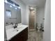 Updated bathroom featuring tile floors, neutral paint, dark bronze fixtures and a shower with neutral tile surround at 623 N Parsell --, Mesa, AZ 85203