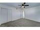 Large bedroom with plush carpeting, a ceiling fan, and closet doors at 623 N Parsell --, Mesa, AZ 85203