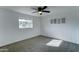 Serene bedroom with plush carpeting, ceiling fan, and a large window providing natural light and a cozy atmosphere at 623 N Parsell --, Mesa, AZ 85203