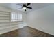 Bright bedroom with plush carpeting, a ceiling fan, built in shelving, and shuttered windows at 623 N Parsell --, Mesa, AZ 85203
