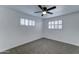 Clean and bright bedroom with plush carpeting, a ceiling fan, and shuttered windows at 623 N Parsell --, Mesa, AZ 85203