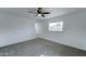Bright bedroom featuring plush carpeting, ceiling fan, and a diamond pane window at 623 N Parsell --, Mesa, AZ 85203