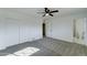 Bright bedroom featuring plush carpeting, ceiling fan, closet doors, and an en-suite bathroom at 623 N Parsell --, Mesa, AZ 85203