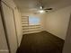 Bedroom with neutral paint, carpet floors, a ceiling fan, built-in shelving and one window at 623 N Parsell --, Mesa, AZ 85203