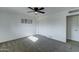 Cozy bedroom with neutral carpet, ceiling fan, closet, and ample light offers a comfortable, relaxing retreat at 623 N Parsell --, Mesa, AZ 85203
