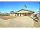 Charming single-story brick home with a long, paved driveway, and minimalist desert landscaping at 623 N Parsell --, Mesa, AZ 85203