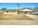 Charming single-story brick home featuring a covered carport and a drought-tolerant front yard at 623 N Parsell --, Mesa, AZ 85203