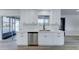 This kitchen offers stainless steel appliances, sleek white cabinets, a dishwasher, and a view of the outdoor pool at 623 N Parsell --, Mesa, AZ 85203