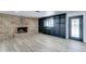Bright living room featuring a brick fireplace, custom shelving, and modern flooring at 623 N Parsell --, Mesa, AZ 85203