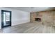 Spacious living room with a brick fireplace, modern flooring, and a sliding glass door at 623 N Parsell --, Mesa, AZ 85203