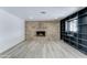 Spacious living room with a cozy brick fireplace and built-in shelving provides ample space for relaxing and entertaining at 623 N Parsell --, Mesa, AZ 85203