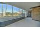 Enclosed patio with brick accent wall and large windows overlooking backyard landscaping at 623 N Parsell --, Mesa, AZ 85203