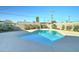 Sparkling blue in-ground swimming pool surrounded by concrete deck and landscaped yard at 623 N Parsell --, Mesa, AZ 85203