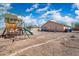 Fenced backyard with play structure and desert landscaping offering a great space for outdoor activities at 6922 S 26Th Ln, Phoenix, AZ 85041