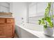 Bright bathroom features a soaking tub with tiled surround at 6922 S 26Th Ln, Phoenix, AZ 85041