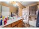 Bathroom features a single-sink vanity, large mirror, and a shower-tub combo with cute Snoopy curtain at 6922 S 26Th Ln, Phoenix, AZ 85041