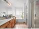Spacious bathroom with wood vanity, soaking tub, and glass enclosed shower at 6922 S 26Th Ln, Phoenix, AZ 85041