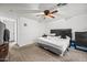 Comfortable bedroom features neutral carpeting, a ceiling fan, and nice furniture at 6922 S 26Th Ln, Phoenix, AZ 85041