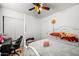 Bright bedroom with fan light and a white, four-poster bed. A desk sits to the side for work or hobbies at 6922 S 26Th Ln, Phoenix, AZ 85041