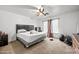 Spacious bedroom features a ceiling fan and a large window for plenty of natural light at 6922 S 26Th Ln, Phoenix, AZ 85041