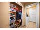 Walk-in closet features extensive shelving for clothes and shoes and opens into a laundry area at 6922 S 26Th Ln, Phoenix, AZ 85041