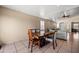 Bright and airy dining area open to the living room with tile floors and neutral walls at 6922 S 26Th Ln, Phoenix, AZ 85041
