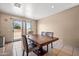 Cozy dining area features a wooden table, tile floors, and a sliding glass door to the backyard at 6922 S 26Th Ln, Phoenix, AZ 85041