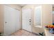Clean entryway features a white front door, closet, and tiled floor at 6922 S 26Th Ln, Phoenix, AZ 85041