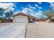 Single-story home featuring desert landscaping, attached two-car garage and concrete driveway at 6922 S 26Th Ln, Phoenix, AZ 85041