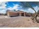 Single-story home with desert landscaping, two-car garage and a walkway to the front door at 6922 S 26Th Ln, Phoenix, AZ 85041