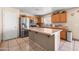Functional kitchen with wood cabinets, stainless appliances, and a central island at 6922 S 26Th Ln, Phoenix, AZ 85041