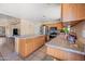 Well-equipped kitchen featuring tile floors, wooden cabinets, and modern appliances at 6922 S 26Th Ln, Phoenix, AZ 85041